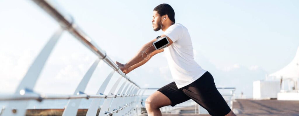 A man is running on the bridge with his phone