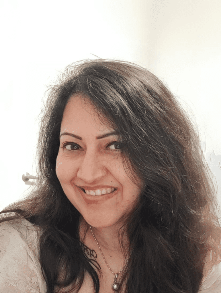 Smiling woman with long dark hair.